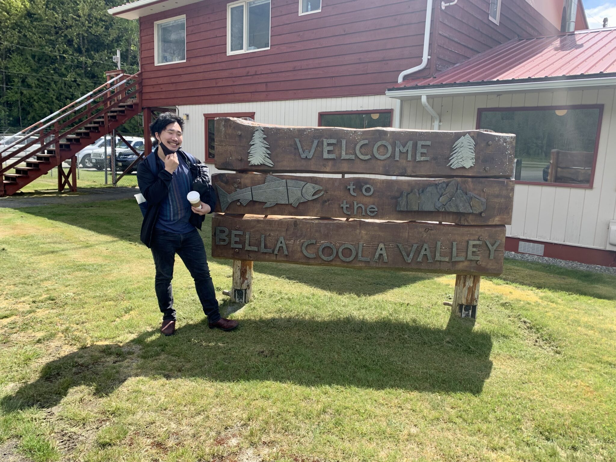 Ben Chung, in front of Bella Coola Valley welcome sign